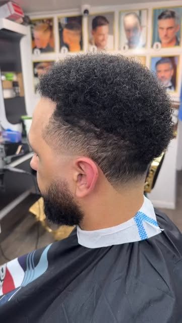 Curls on top, skin fade and beard