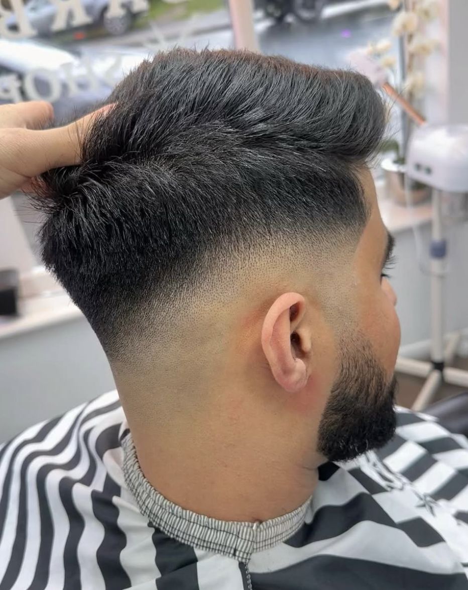 Skin fade with quiff and beard